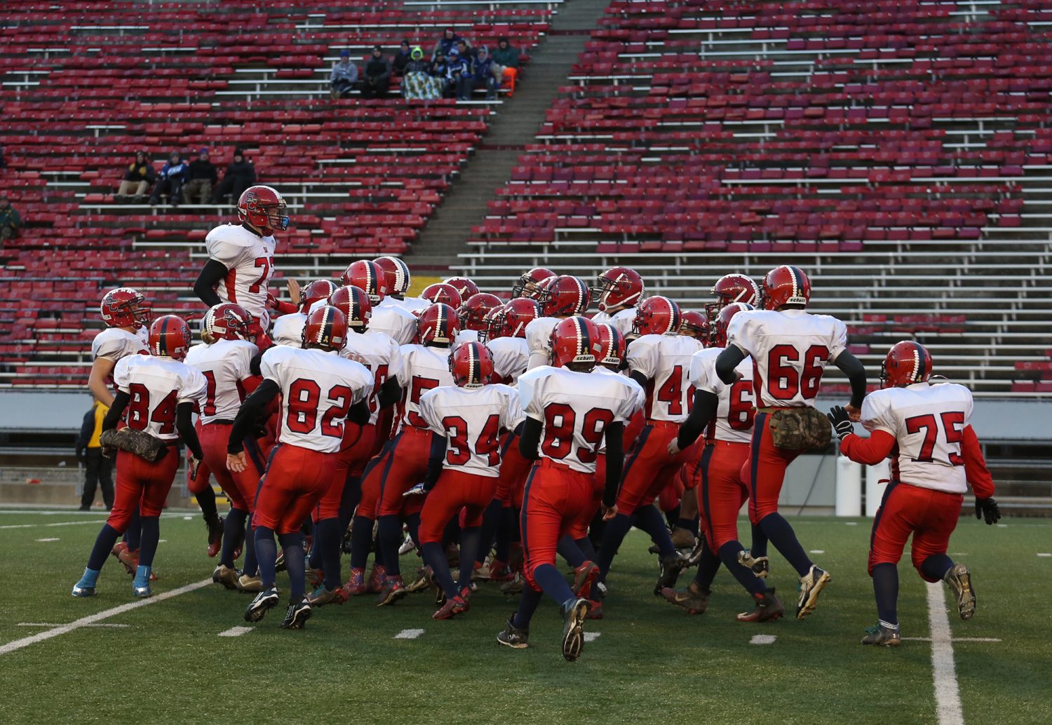 Spencer/Columbus' Dakota Andreae jumps above his teammates as the Rockets were introduced before losing to Amherst 42-0 in the WIAA Division 5 State Championship Game at Camp Randall Stadium in Madison, Thursday, Nov. 19, 2015.