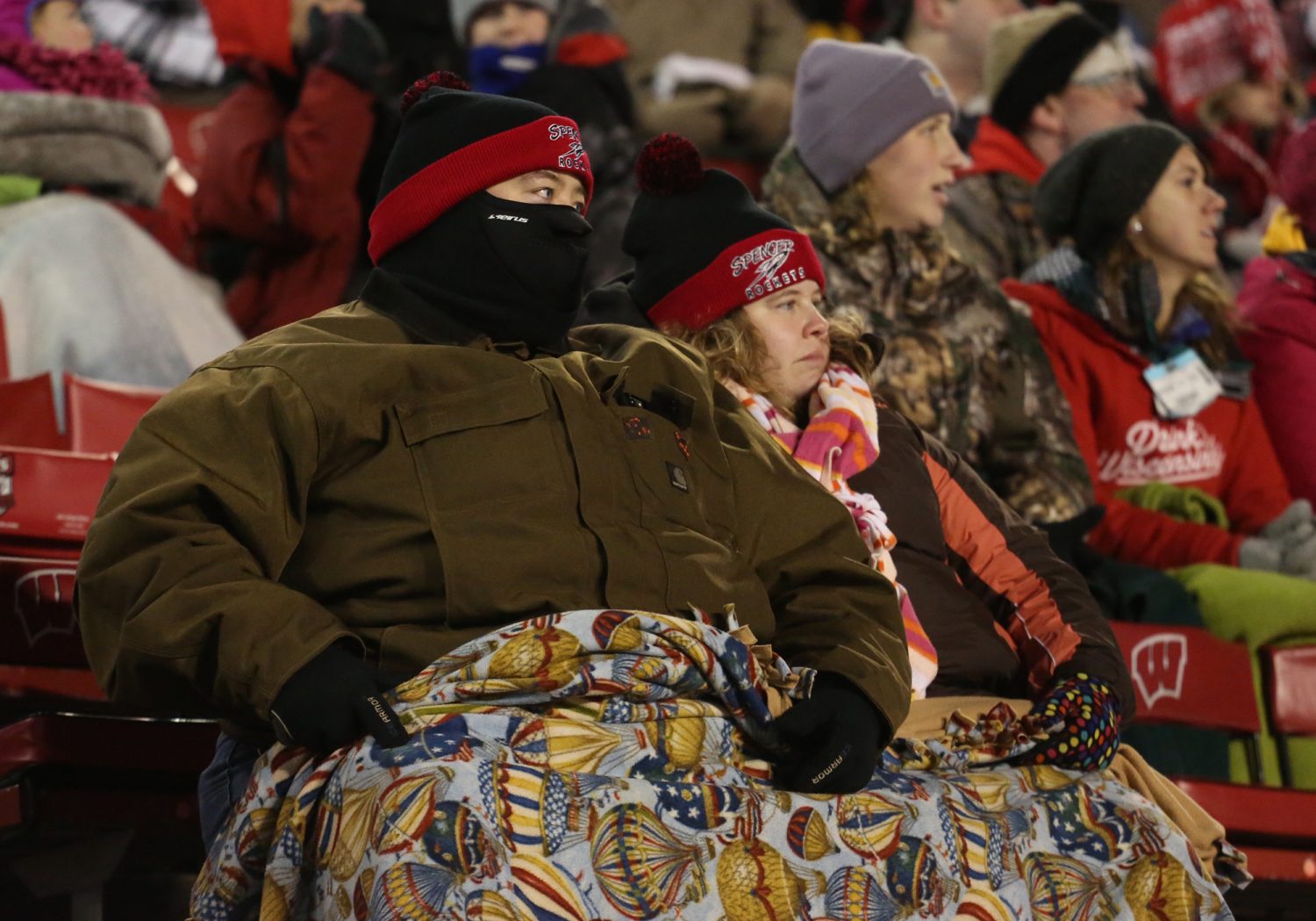 Joel Cieslinski and his wife Melissa of Spencer are bundled up against the cold as the Rockets lost to Amherst 42-0 in the WIAA Division 5 State Championship Game at Camp Randall Stadium in Madison, Thursday, Nov. 19, 2015.
