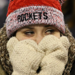 Disappointed Spencer 10th grader Sadie Mercier covers much of her face as she watches action in the third quarter as the Rockets lost to Amherst, 42-0, in the WIAA division 5 state championship game at Camp Randall Stadium in Madison, Thursday, November 19, 2015.