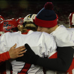 From left, Carson Hildebrandt, Calvin Lenz, and Brett Loveland hug after the Rockets lost to Amherst 42-0 in the WIAA Division 5 State Championship Game at Camp Randall Stadium in Madison, Thursday, Nov. 19, 2015.