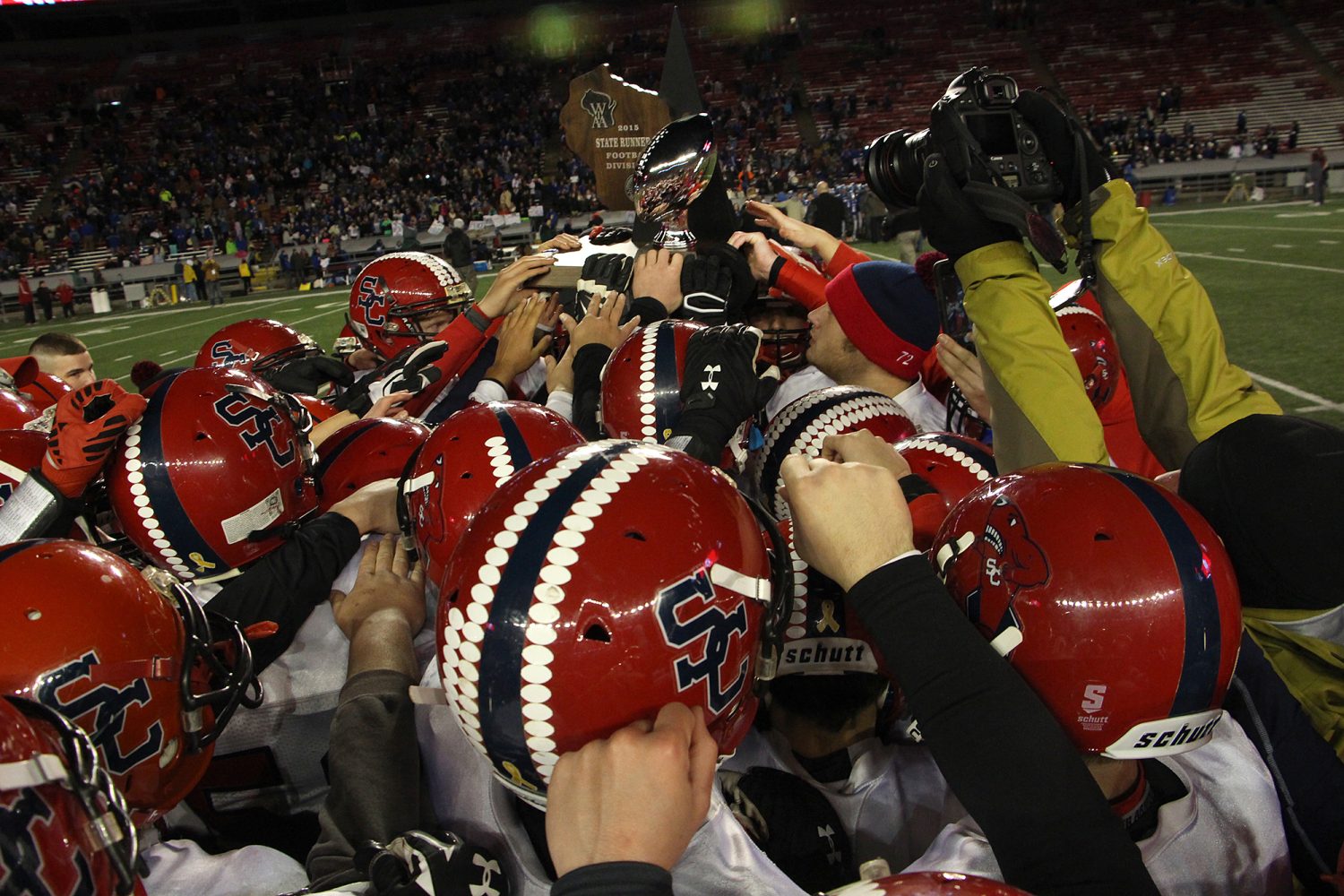 Spencer/Columbus players hoist their second-place trophy after the Rockets lost to Amherst 42-0 in the WIAA Division 5 State Championship Game at Camp Randall Stadium in Madison, Thursday, Nov. 19, 2015.