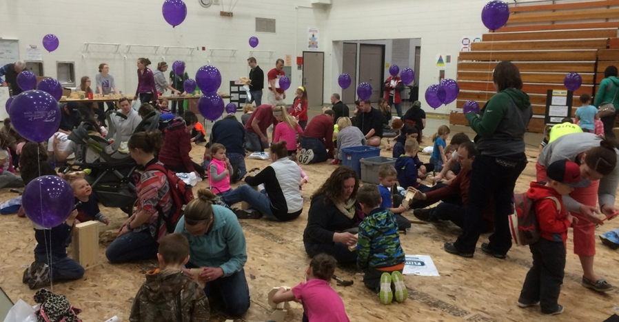 At the 2015 Children’s Festival, children and their parents make wooden toys from materials donated by the Central Wisconsin Home Builders Association.