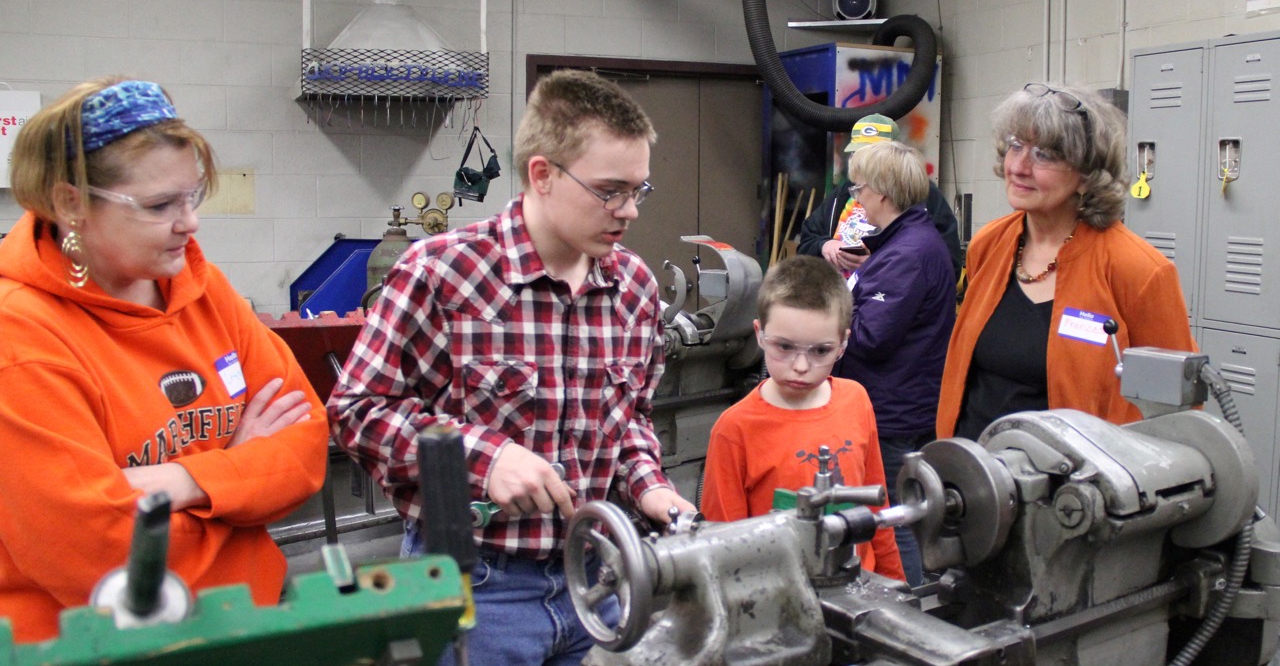 Sophomore Jared Radlinger, second from left, showcases his talents at Marshfield High School’s metal tech open house.