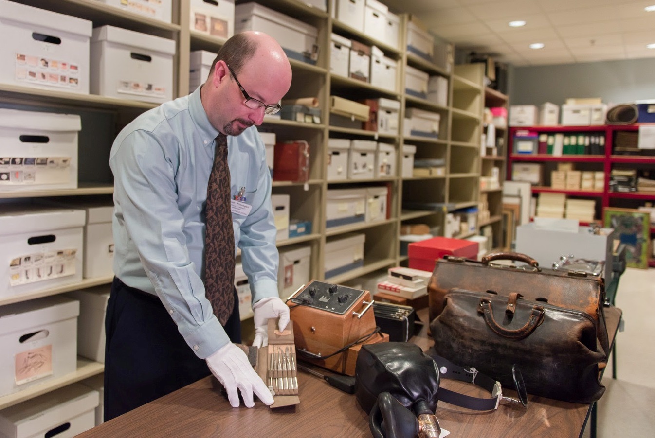 Brian Finnegan, manager of the George E. Magnin Medical Library and History Archive at Marshfield Clinic, displays medical equipment used in years past by clinic physicians.