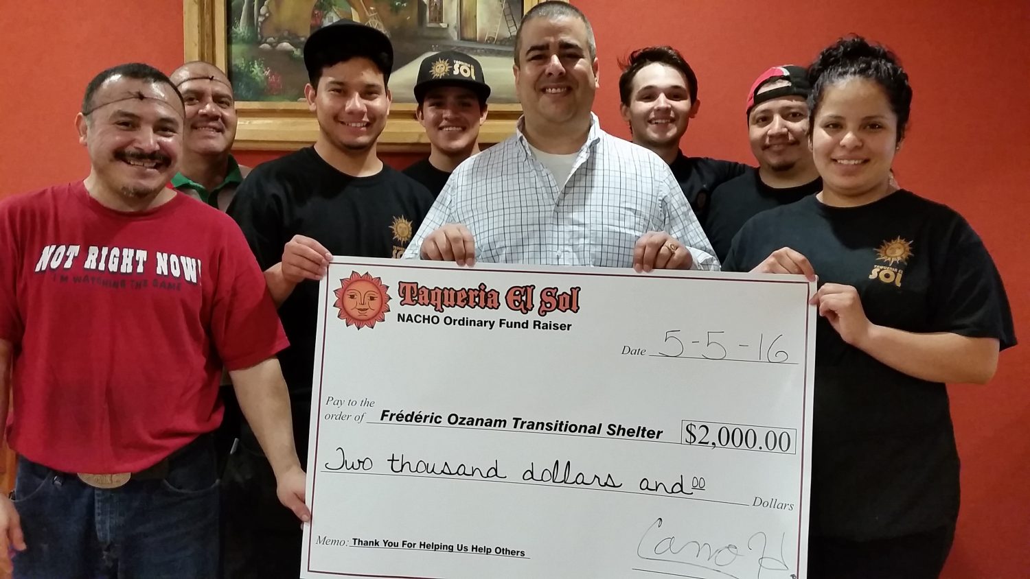 Taqueria El Sol staff pose with a check for $2,000, which will be donated to the Fredric Ozanam Transitional Shelter as a result of Nacho Ordinary Fundraiser held at the restaurant on May 5.