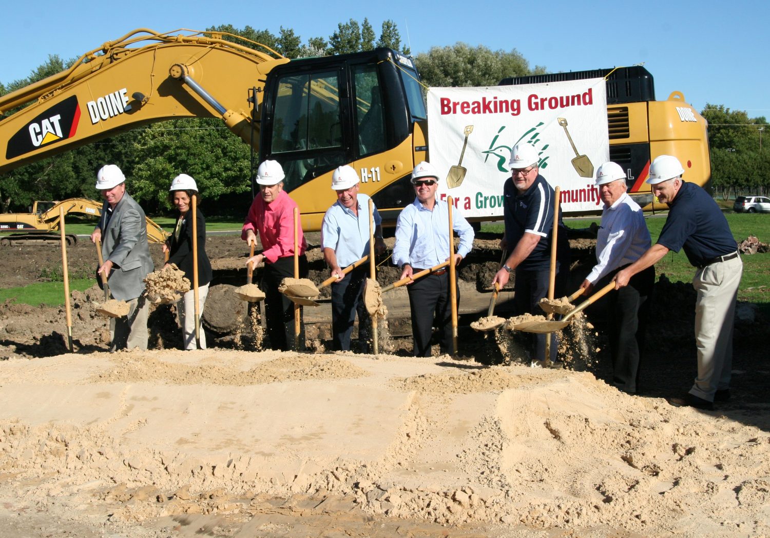 From left: Forward Financial staff members Bill Sennholz, president and CEO; Lori Gropp, board chair; Bill Mork; Scott Rollins; Brian Kief; Al Michalski; Orin Toltzman; and John Marshall throw out the first scoop during the Sept. 8 groundbreaking of the new Forward Financial Bank facilities.
