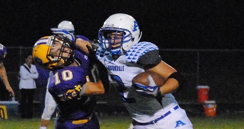 Auburndale running back Collin Hawkins stiff arms a Pittsville defender on his way to a first-down run during Friday night’s game at Pittsville High School. The Apaches won 12-8.