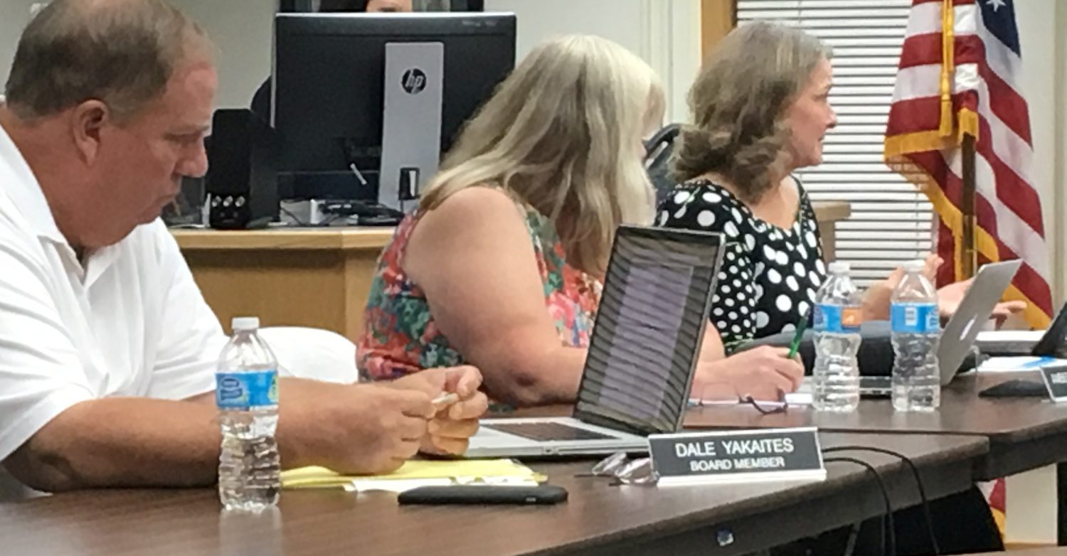 Marshfield School Board members (from left) Dale Yakaites, Amber Leifheit, and Frances Bohon discuss action at a meeting Sept. 14.