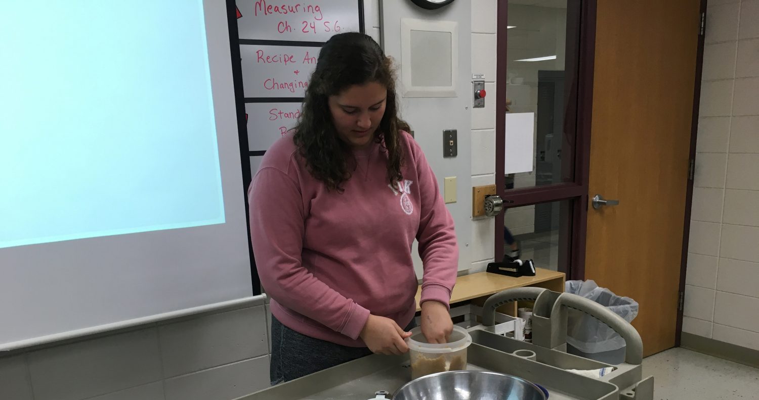 Amy Martorano measures brown sugar using techniques learned in her Food, Family and Society class at Marshfield High School.
