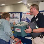Marshfield Police Department Lieutenant Darren Larson receives unused and expired medicine from Mary Bass. The take back station is just one of three scheduled prescription take back events in Marshfield. Upcoming events will be held Friday, Oct. 21, at the Marshfield Clinic and Saturday, Oct. 22, at Shopko. Hub City Times staff photo.