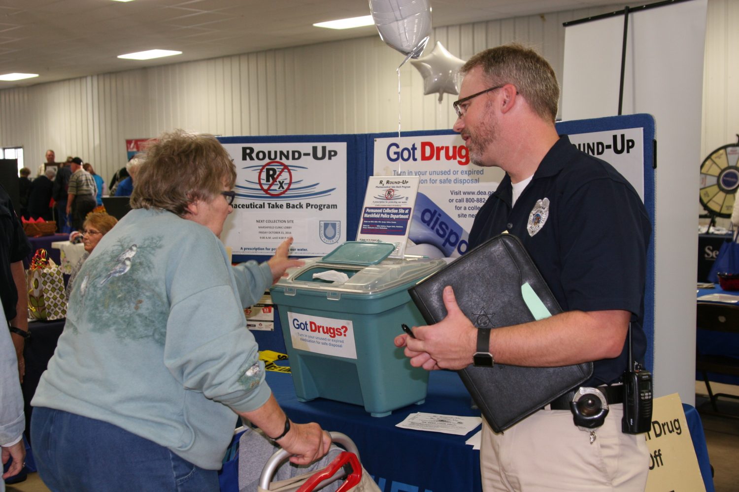 Marshfield Police Department Lieutenant Darren Larson receives unused and expired medicine from Mary Bass. The take back station is just one of three scheduled prescription take back events in Marshfield. Upcoming events will be held Friday, Oct. 21, at the Marshfield Clinic and Saturday, Oct. 22, at Shopko. Hub City Times staff photo.
