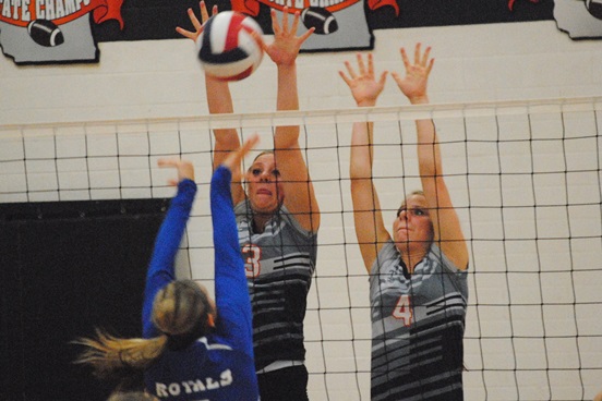 Stratford’s Makayla Krall, left, and Blaire Lindner go up for a block during the Tigers’ match against Wisconsin Rapids Assumption on Tuesday at Stratford High School. The Tigers won 3-0.
