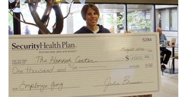 Diana Ugoretz, senior Marshfield Clinic payroll assistant, holds the check donated to the Hannah Center through Security Health Plan's Monthly Employee-Driven Corporate Giving campaign.