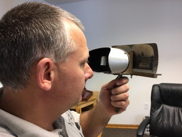 Current Marshfield Monument owner Brian Hopperdietzel demonstrates how a stereoscope works.