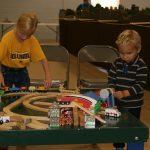 Abigail and Nicholas Wojcik build their own railroad at the toy train station. Hub City Times Staff photo.