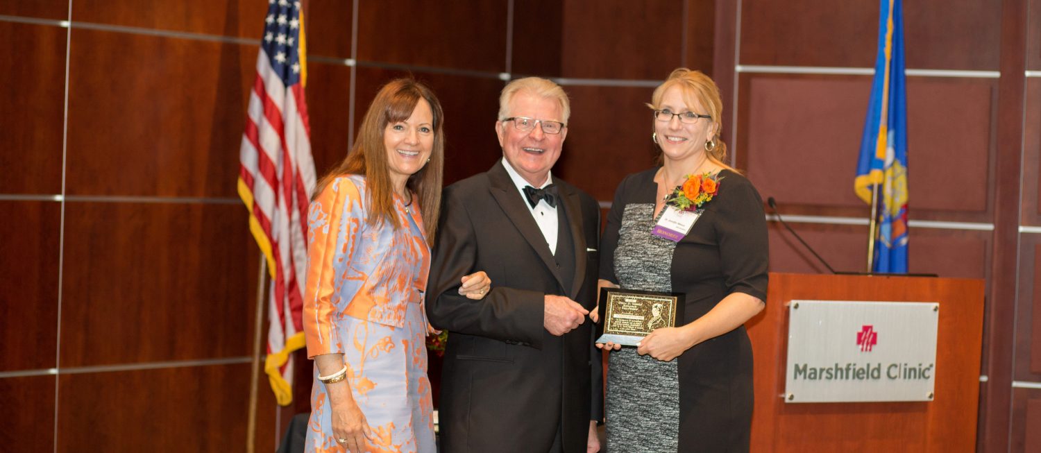 Marshfield Clinic Research Foundation’s Integrated Research and Development Laboratory Director Jennifer Meece, right, recently received the Gwen D. Sebold Fellowship for Outstanding Research. She was presented the award by D. David “Dewey” Sebold and his wife, Dani Sebold.