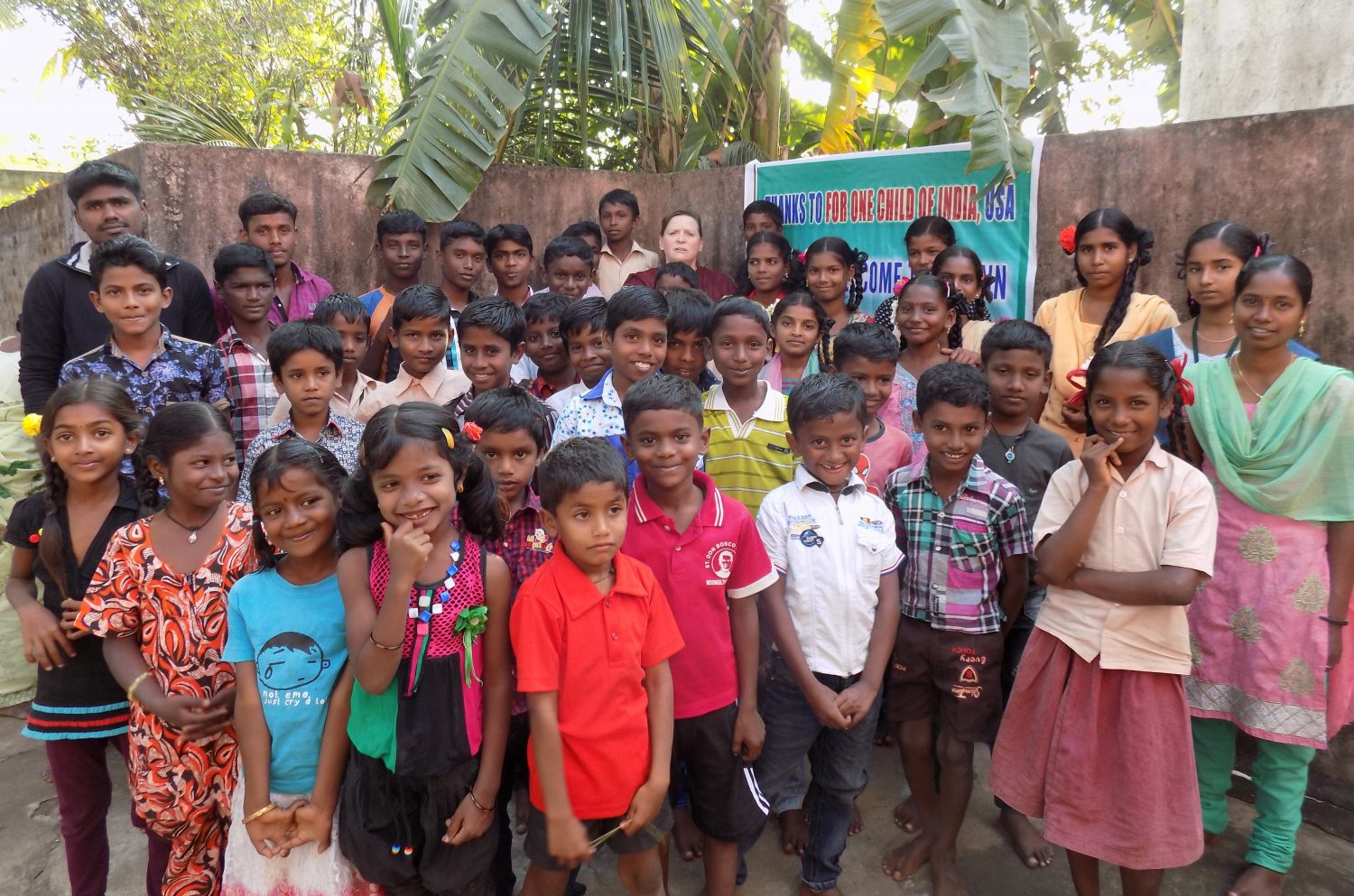 RaeAnn Thomas Gust (back row, center) surrounded by children from Eleanganny, India.