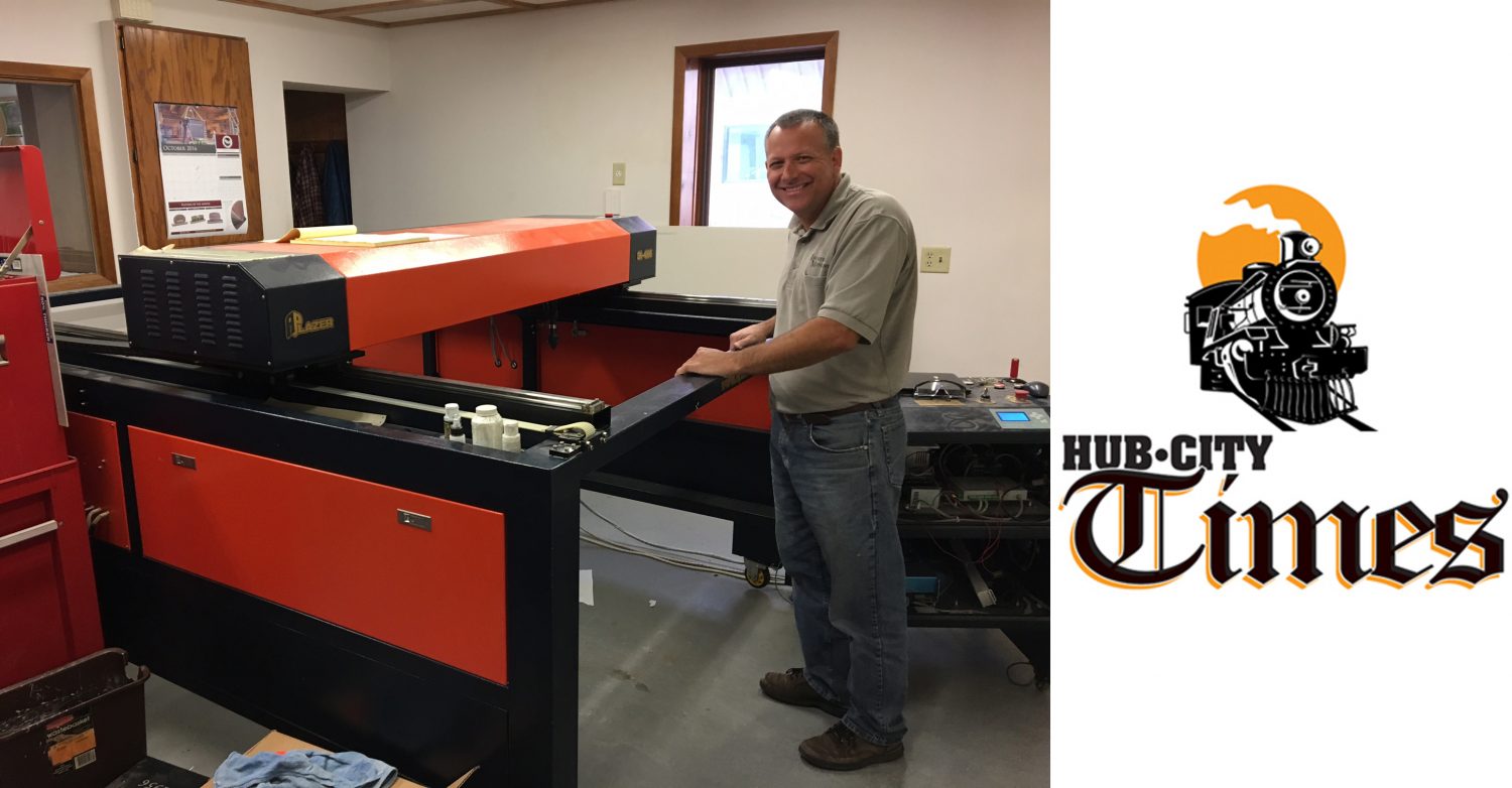 Marshfield Monument owner Brian Hopperdietzel stands with the shop's 4-by-8 laser etcher.