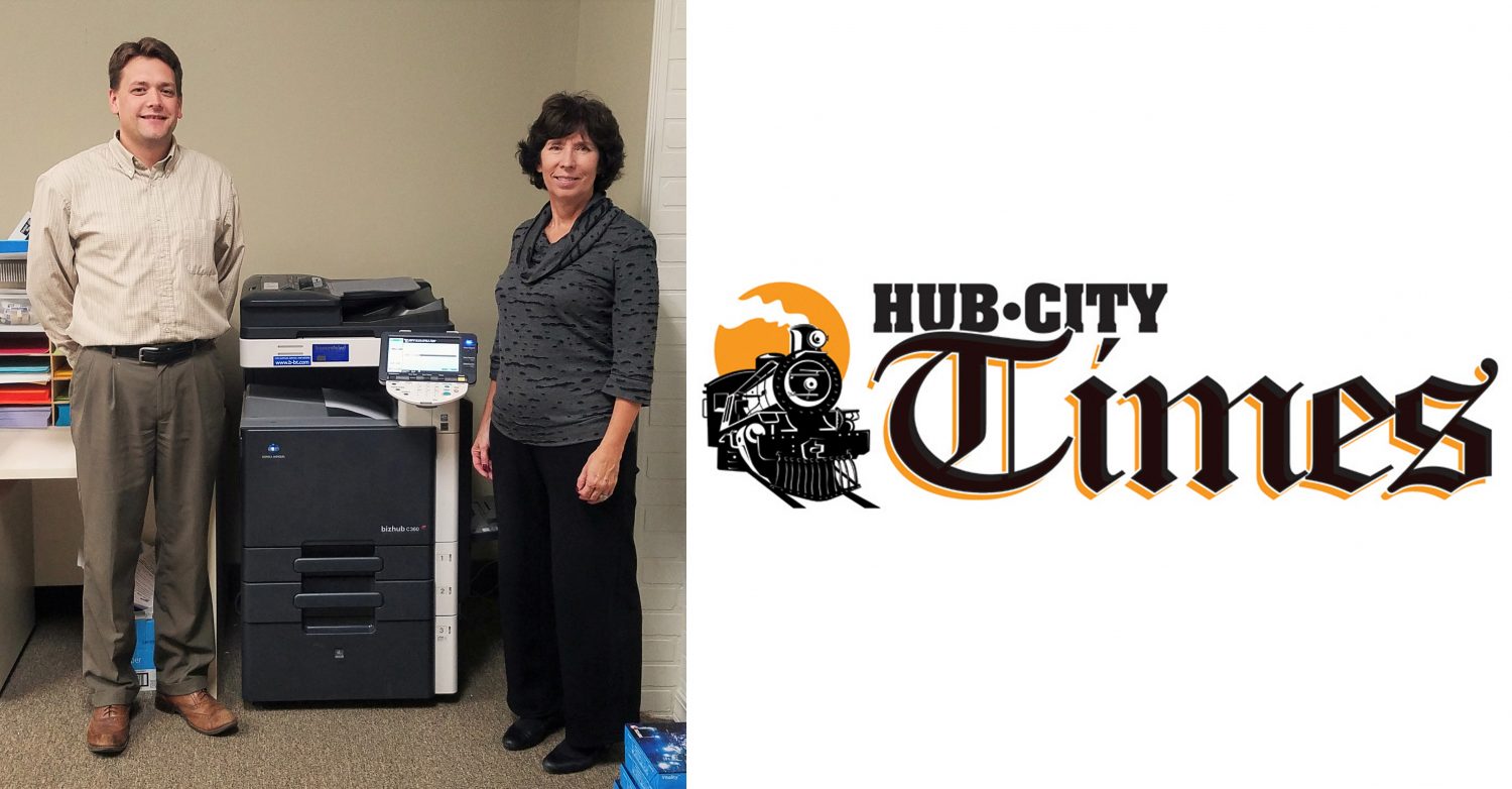 Paul Knoff, account representative at Bauernfeind Business Technologies Inc., and Paula Jero, Marshfield Area United Way executive director, stand next to the copier Bauernfeind recently donated to the United Way.