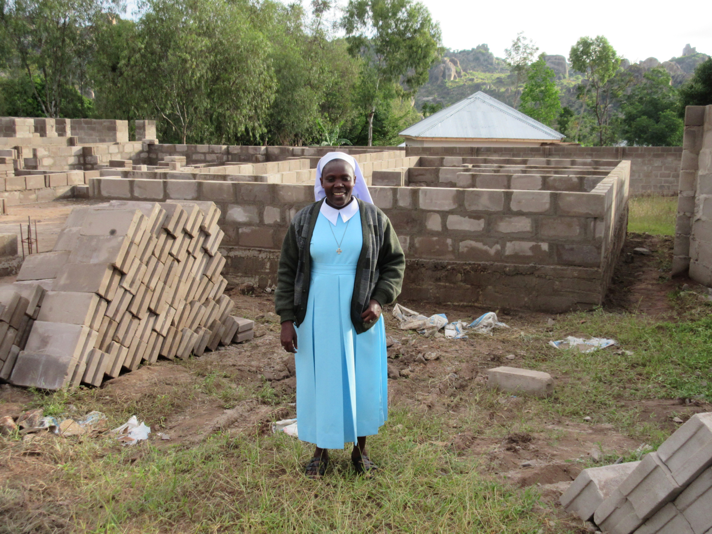 In 2014 Sister Sabina Kabuga stands in front of the foundation for the Divine Mercy Convent, which was constructed after an initial $15,000 donation by St. John the Bapist Catholic Church to the Sisters of Our Lady Queen of Africa in Mwanza, Tanzania.