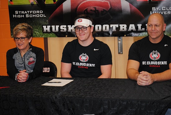 Stratford High School senior Kamren Bornbach, center, signed a letter of intent to play college football at NCAA Division II school St. Cloud State in Minnesota on Wednesday during a ceremony honoring three Tigers that signed their letters to play in the Northern Sun Intercollege Conference. Bornbach is joined by his parents Kristin and Scott Bornbach.