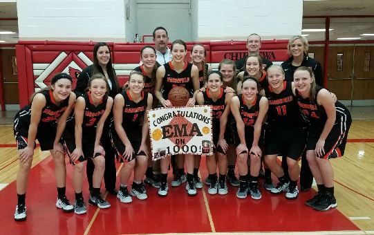 Marshfield senior Ema Fehrenbach, holding sign, surpassed 1,000 points for her career during the Tigers’ win at Chippewa Falls on Tuesday night.