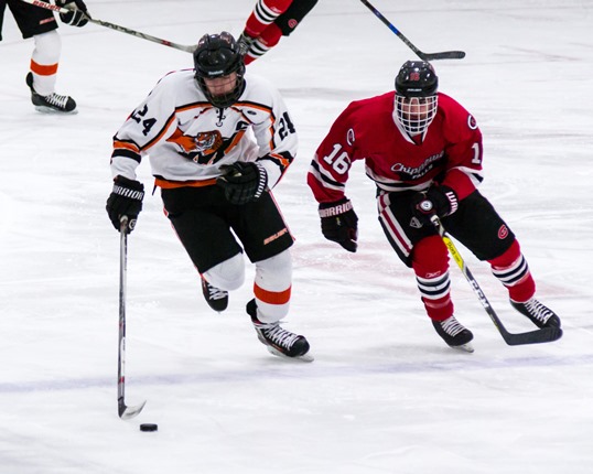Marshfield’s Zach Schmidt, left, controls the puck during the Tigers’ WIAA regional final playoff game Thursday at Chippewa Falls. The Tigers lost 4-0.