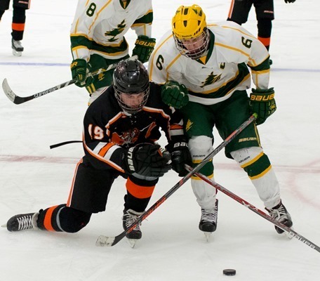 Marshfield’s Justin Stanek, left, battles D.C. Everest’s Ryan Begley for the puck during a game at Greenheck Fieldhouse in Schofield on Thursday.
