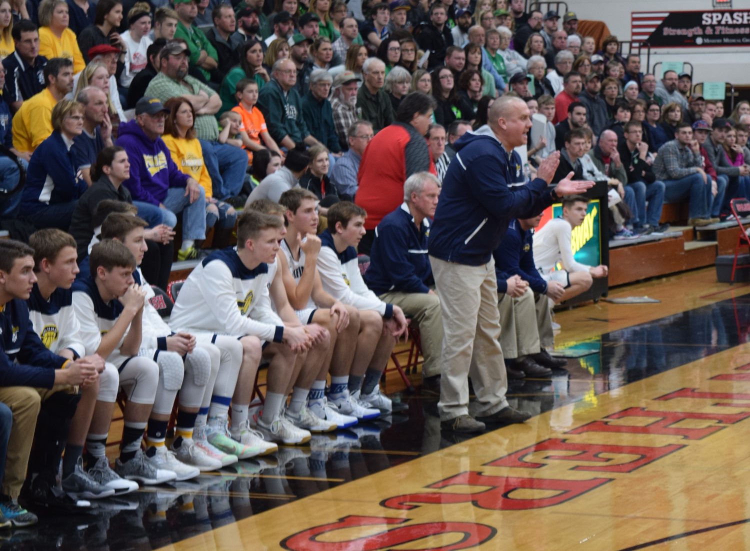 Columbus Catholic boys basketball coach Joe Konieczny, standing, calls out to his team during the Dons' 75-62 win over Almond-Bancroft in a WIAA Division 5 sectional semifinal at Stevens Point Area Senior High on March 9.