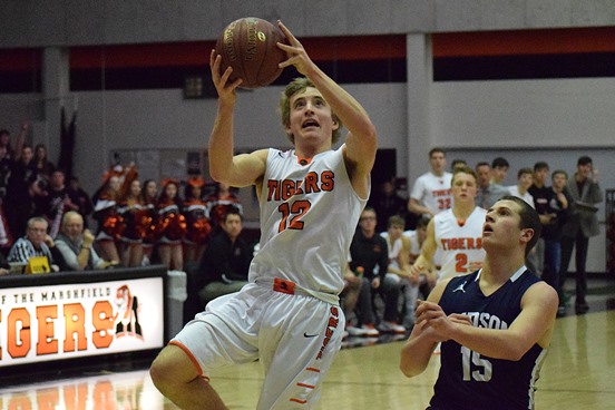 Marshfield’s Alec Hinson drives to the basket for two during the Tigers’ win over Hudson in a WIAA Division 1 boys basketball regional semifinal Friday at Marshfield High School. Hinson finished with a game-high 22 points.