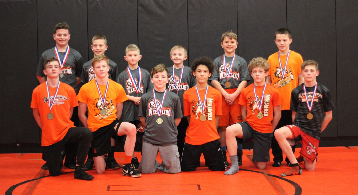 Marshfield youth wrestlers (front row from left) Gavin Young, Ryan Dolezal, Cody Weix, Gabe Pugh, Garrett Willuweit, Brett Franklin, (back row from left) Joey Carolfi, Owen Griesbach, Kashton Kilty, Kash Ostermann, Caleb Dennee, and Hoyt Blaskowski competed in the WWF Kids Folkstyle State Championships at the Alliant Energy Center in Madison March 24-25.  Seven of the twelve wrestlers placed at the tournament. Pugh and Blaskowski took second, Young came in third, Franklin and Carolfi were fourth, Willuweit finished fifth, and Dennee placed sixth.