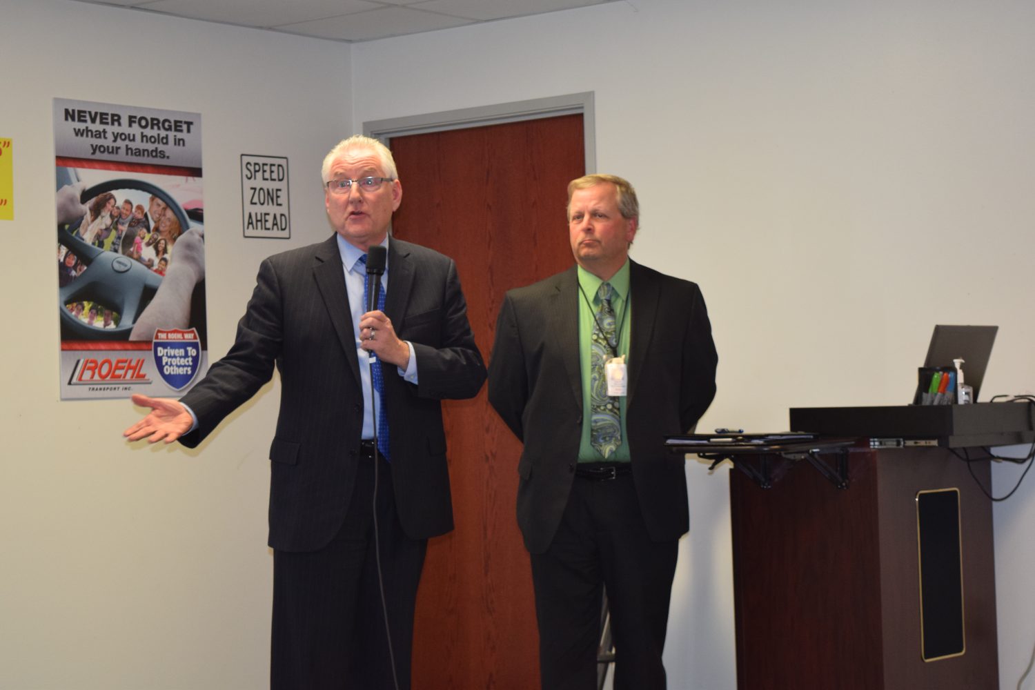 Wisconsin Department of Transportation Secretary Dave Ross, left, speaks at Roehl Transport on April 4 as DOT North Central Manager Russ Habeck looks on.