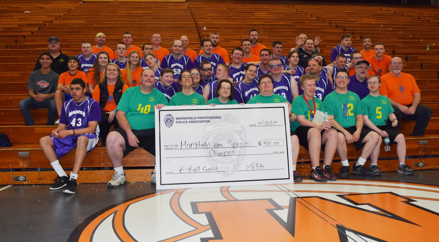 Members of the Marshfield Police Department and Marshfield Area Special Olympics present a check for event proceeds from a charity basketball game on April 21.