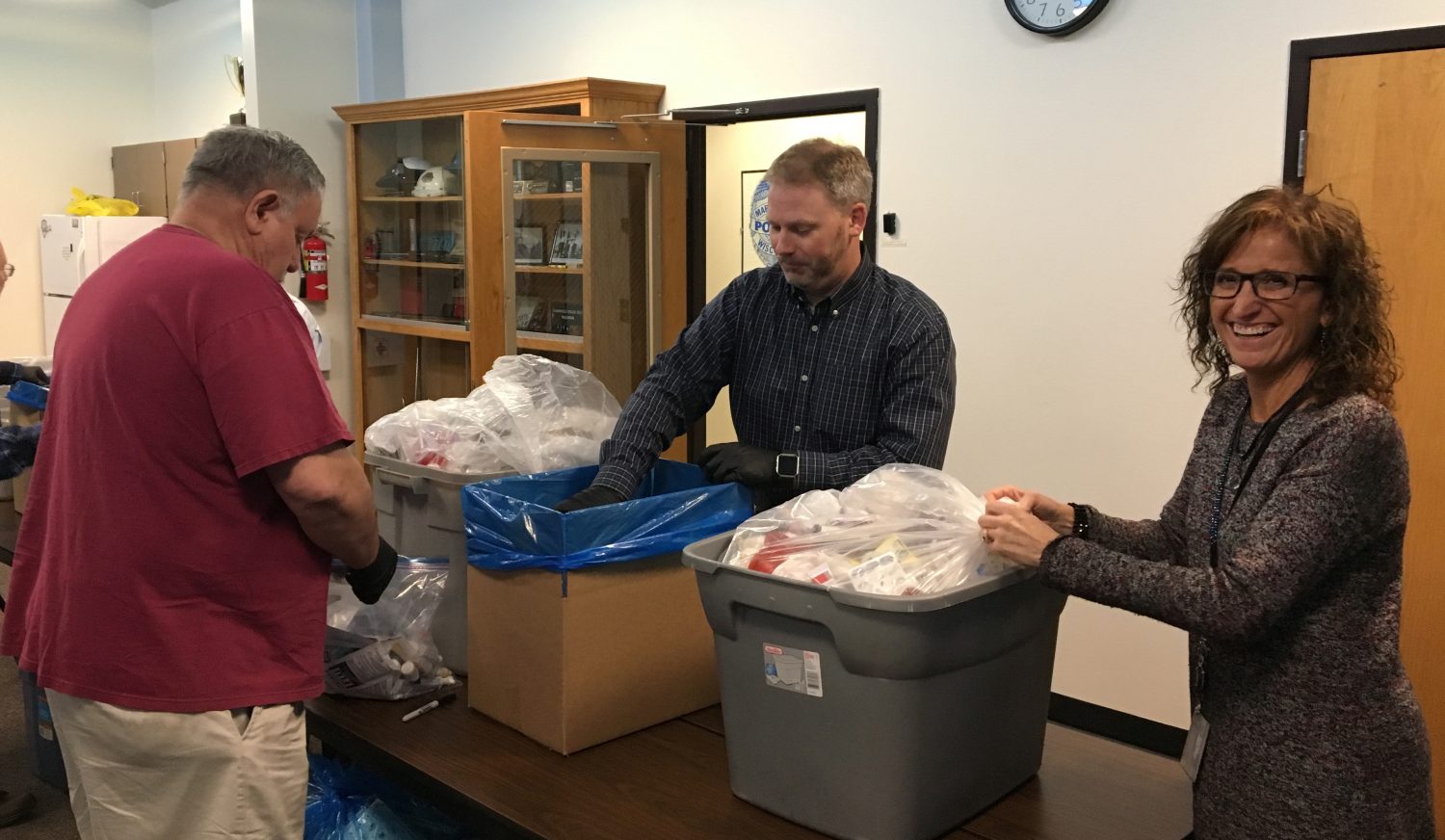 From left: Arnie Mancl, Marshfield Police Lt. Darren Larson, and Kathy Leick sort and prepare submitted drugs before sending them off to be incinerated.
