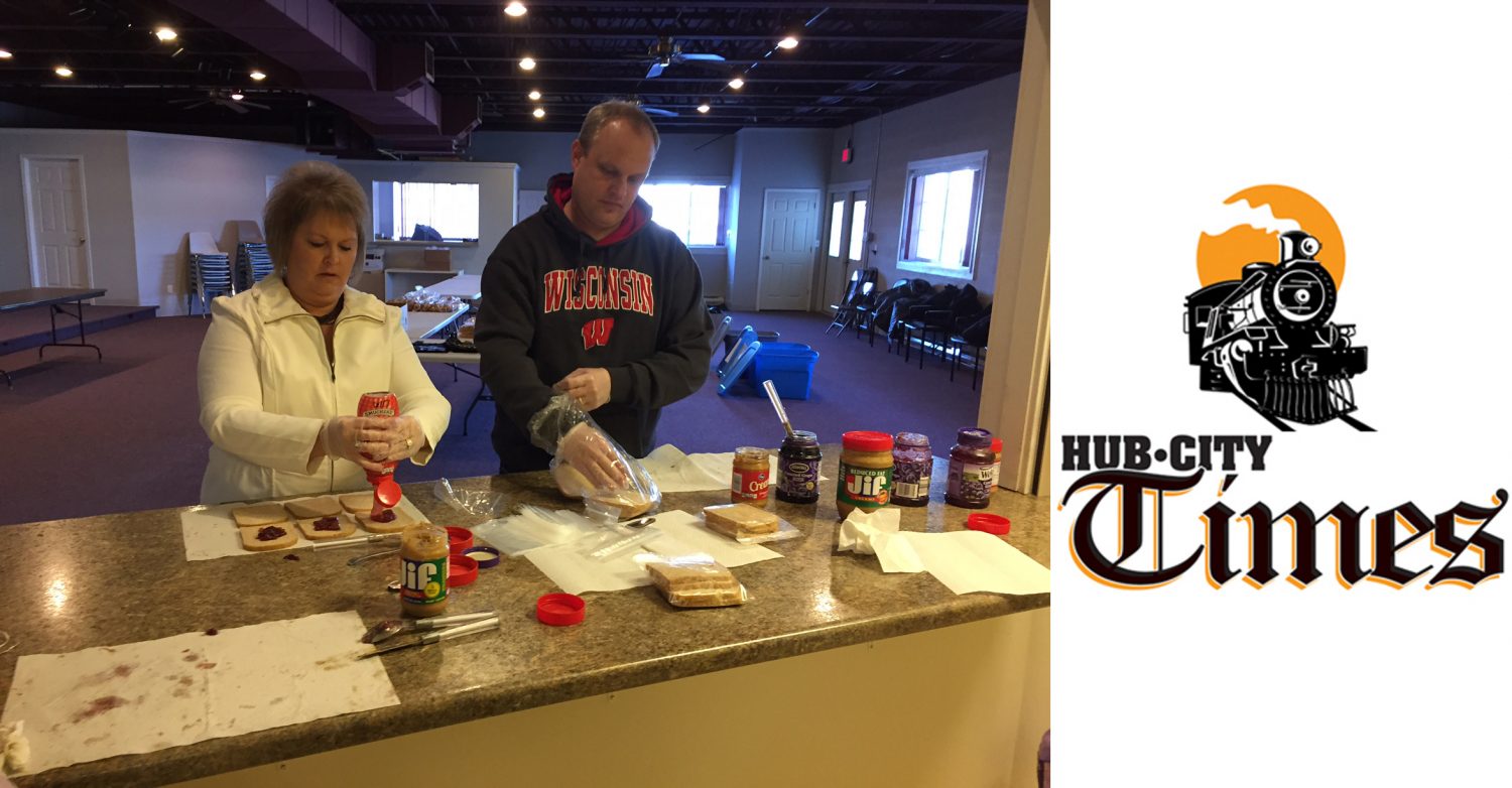 Marshfield city staff members Deb Hall and Ben Steinbach prepare peanut butter and jelly sandwiches for distribution. The Nutrition On Weekends program relies heavily on volunteers for its operation.