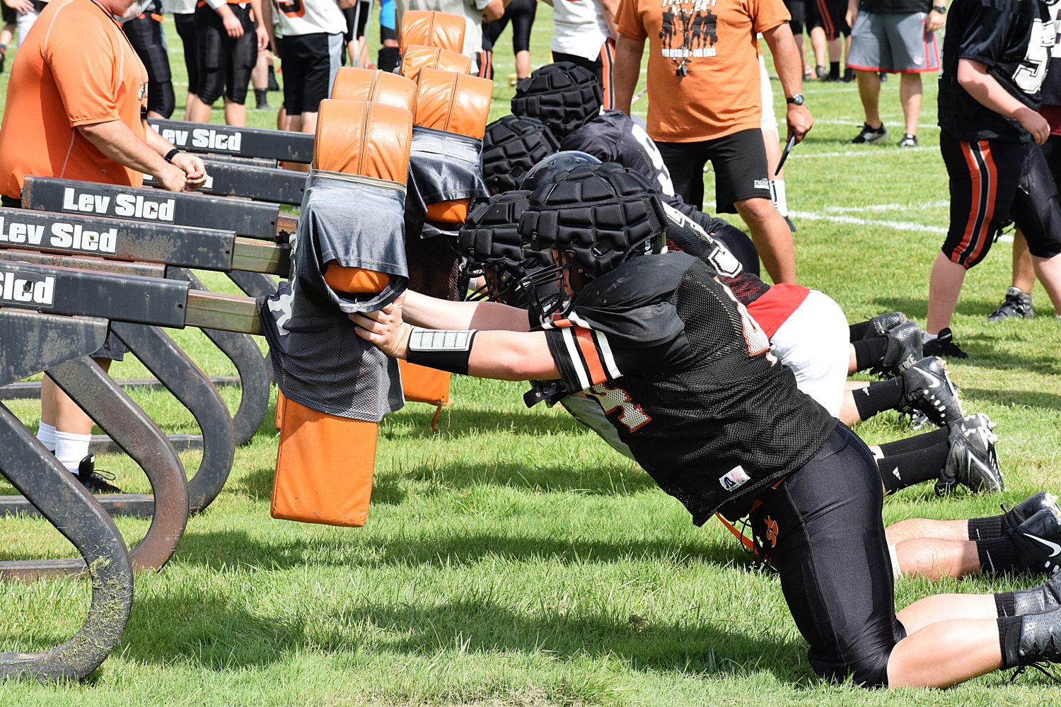 A group of Marshfield linemen work on the blocking sled during a preseason practice. The Tigers open their season Aug. 18 at Oshkosh West.