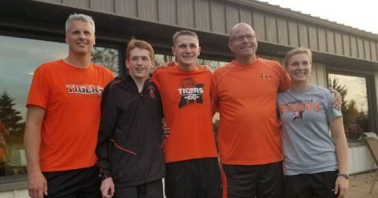Marshfield’s Joseph McKee (second from left) and Jordan Dzikowich (middle) celebrate with the Marshfield High School cross country coaches after qualifying for the state meet with top-six finishes at the WIAA Division 1 sectional Friday at Lake Breeze Golf Course in Winneconne.