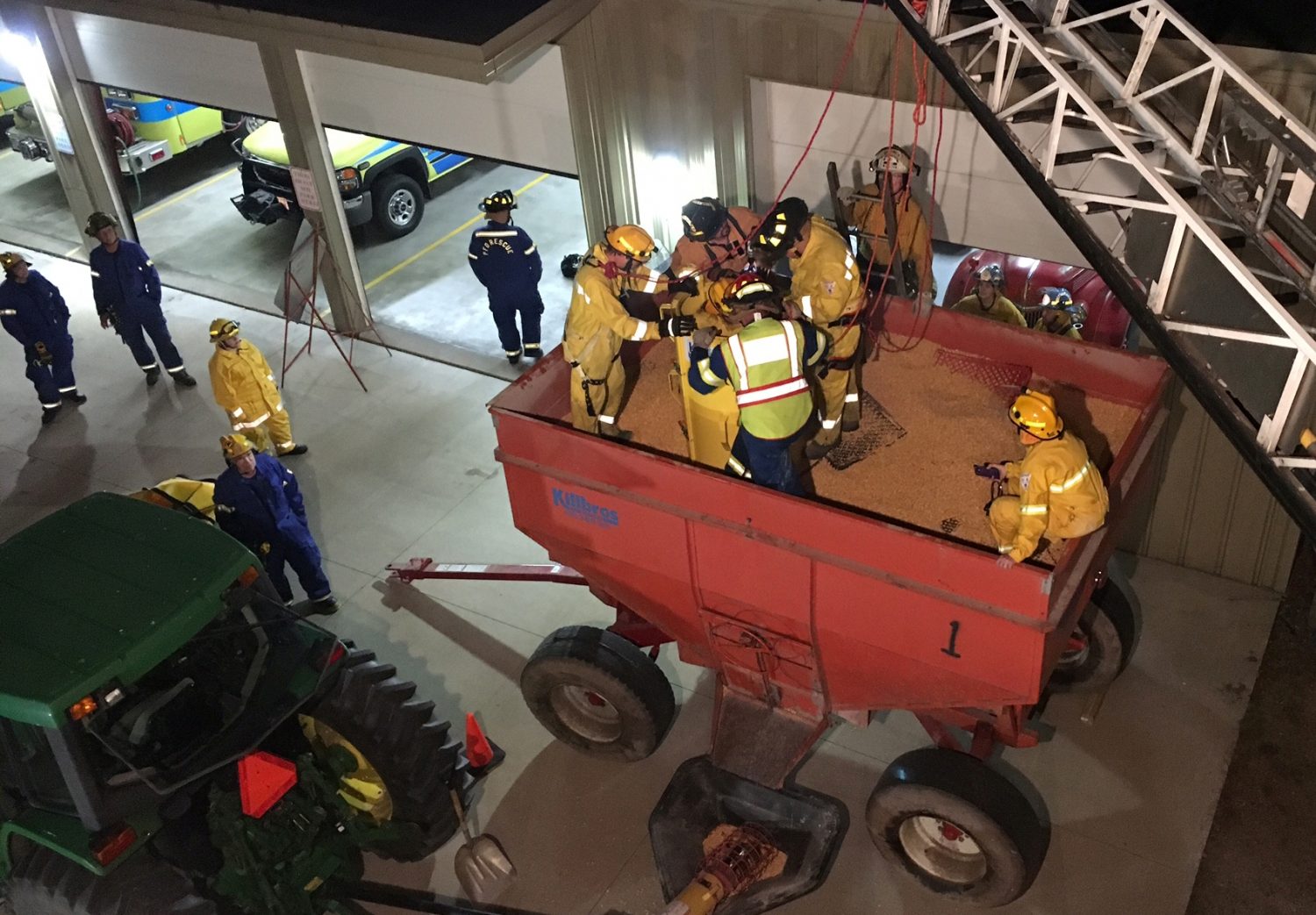 Members of local fire and rescue teams work to free a “victim” from a grain bin during a collaborative training session held at the Pittsville Fire Department on Sept. 25.