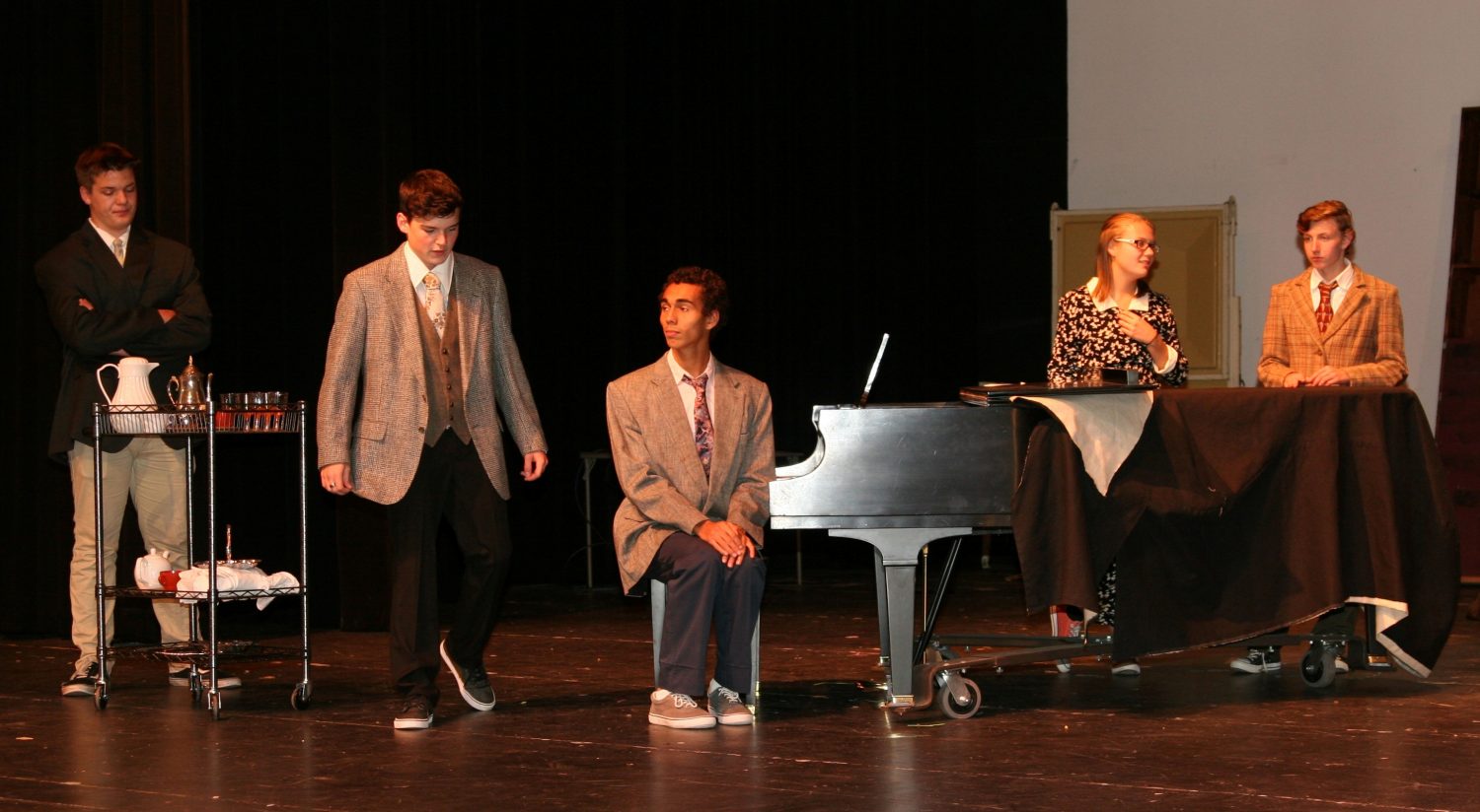 From left: Brandon Koran, Tanner Kuehmichel, Nathaniel Phillips, Kinsey Regehr-Hadden, and Hunter Karau practice a scene from “The Musical Comedy Murders of 1940.”