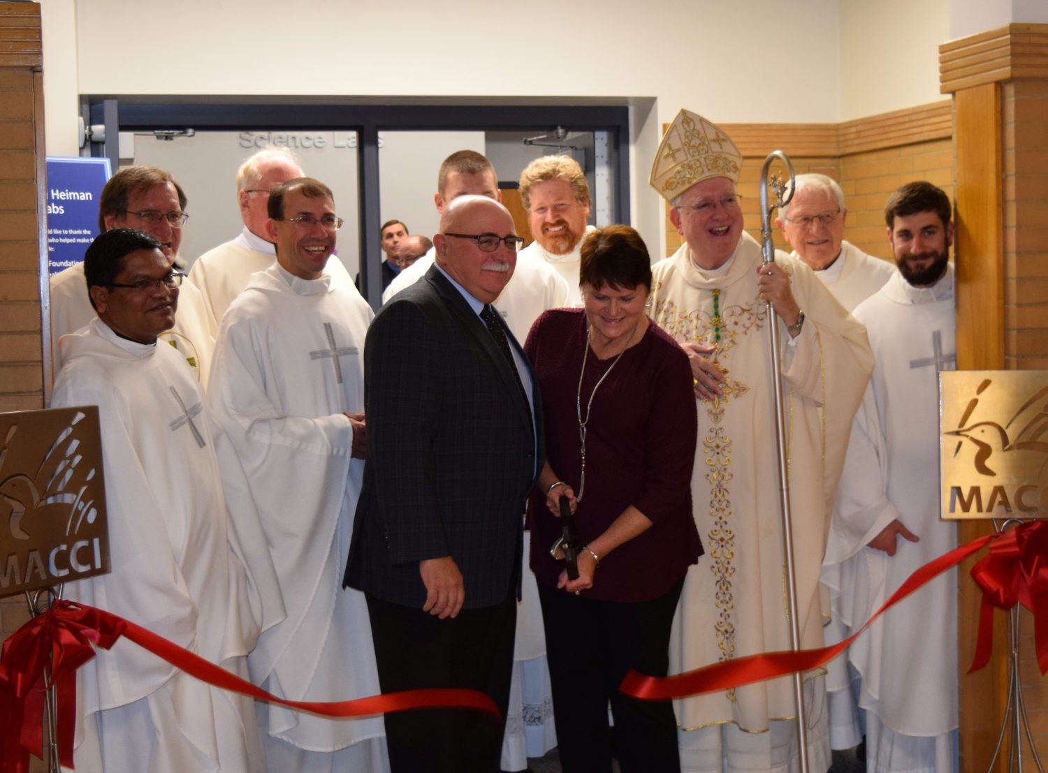 Joellen Heiman (front row, center) snips the ribbon to commemorate the grand opening of the Ken & Joellen Heiman Science Labs at Columbus Catholic High School on Oct. 27.